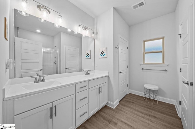 bathroom featuring vanity, hardwood / wood-style floors, and an enclosed shower