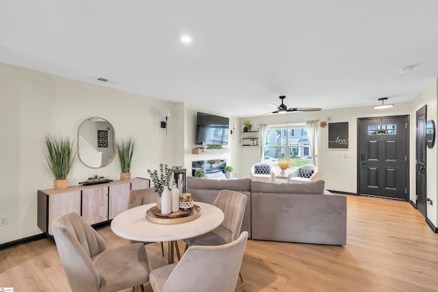 dining space featuring ceiling fan and light hardwood / wood-style flooring