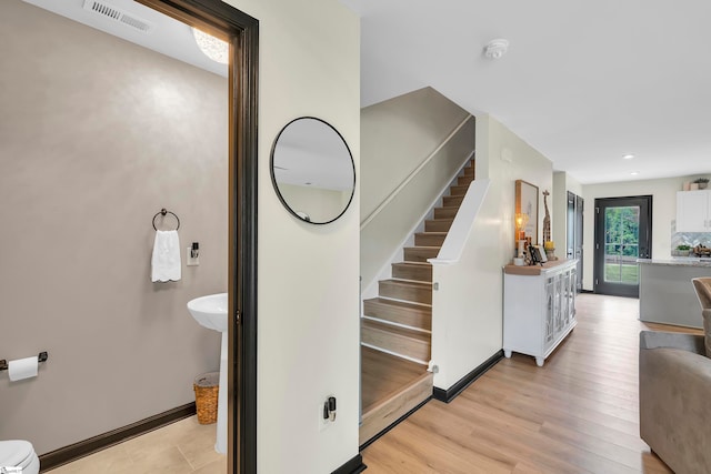 stairway featuring wood-type flooring