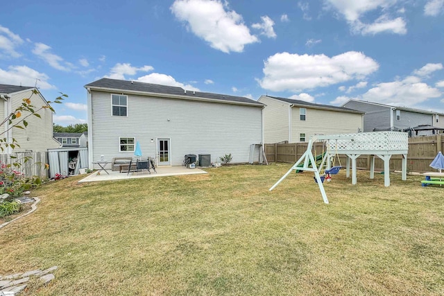 back of house featuring central AC unit, a lawn, and a patio