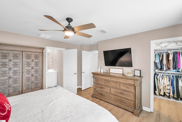 bedroom with a closet, light wood-type flooring, and ceiling fan