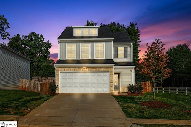 view of front of home with a lawn and a garage