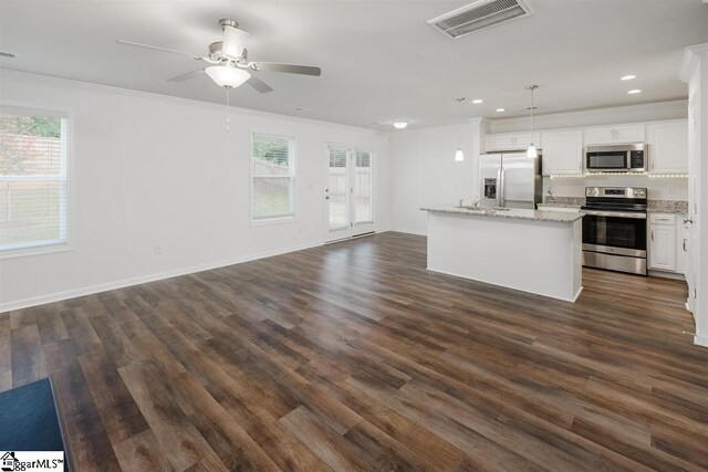 kitchen with pendant lighting, white cabinetry, appliances with stainless steel finishes, and plenty of natural light