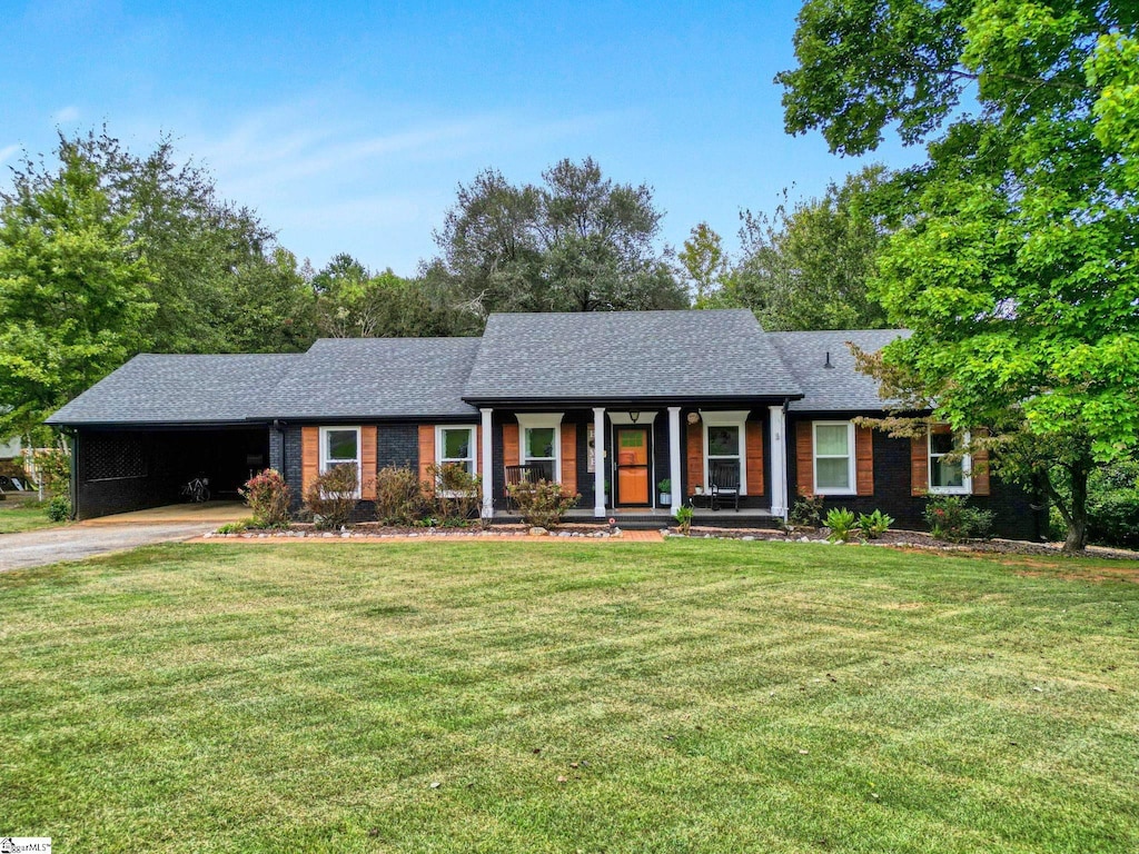 ranch-style house with a front yard and a carport