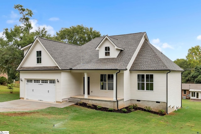 view of front facade with a garage, a front yard, and covered porch