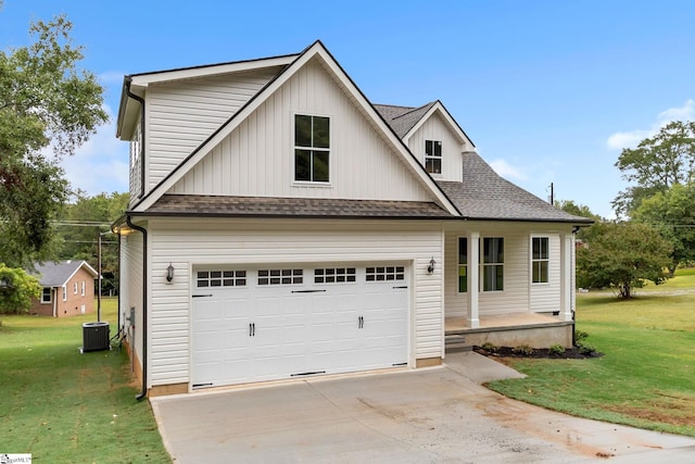 view of front of property featuring central air condition unit, a front yard, and a garage