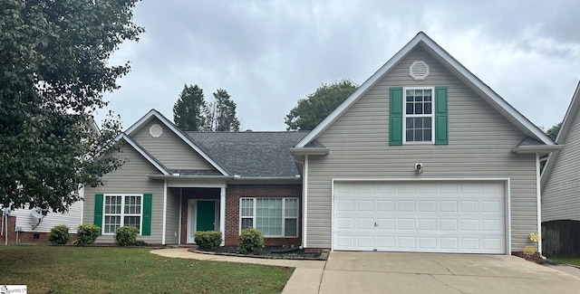 view of front of house with a garage and a front lawn