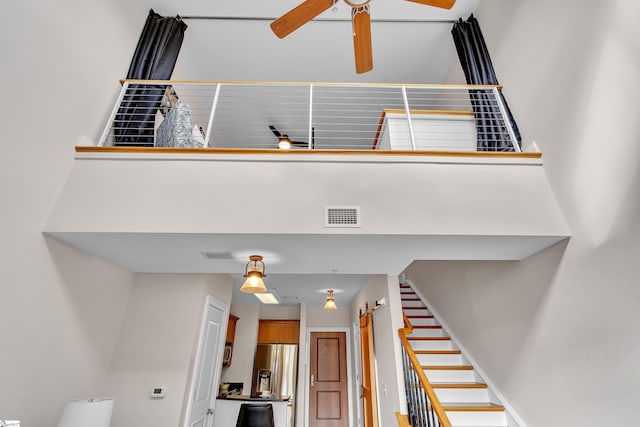 stairway with ceiling fan