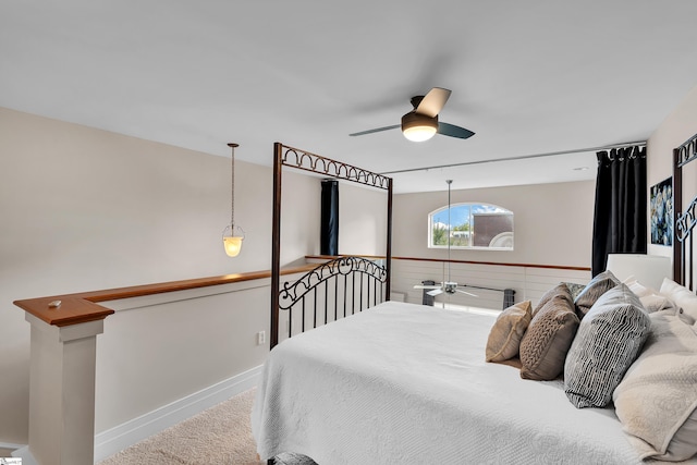 carpeted bedroom featuring track lighting and ceiling fan