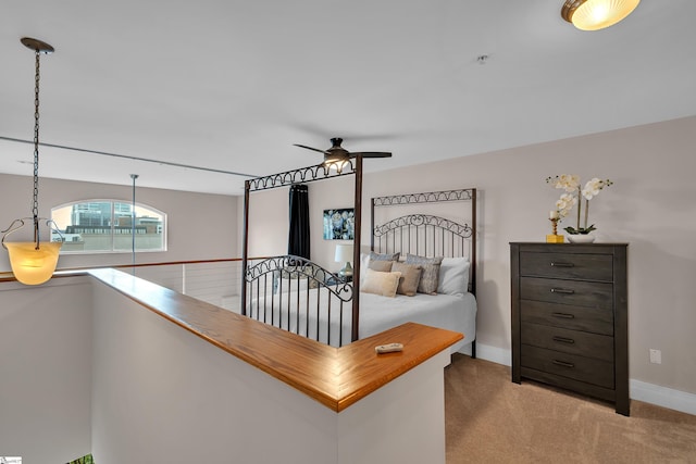 bedroom featuring light carpet and ceiling fan