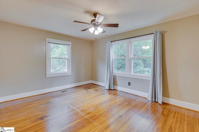 spare room with light wood-type flooring and ceiling fan