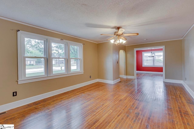 unfurnished room featuring ceiling fan, a textured ceiling, light hardwood / wood-style flooring, and ornamental molding