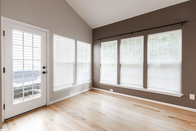 unfurnished sunroom with lofted ceiling