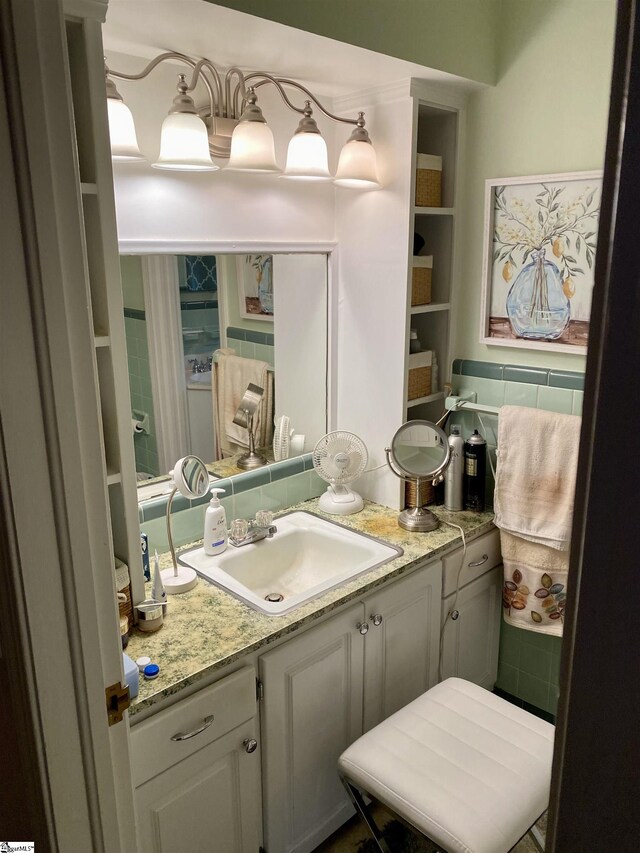 bathroom with decorative backsplash and vanity