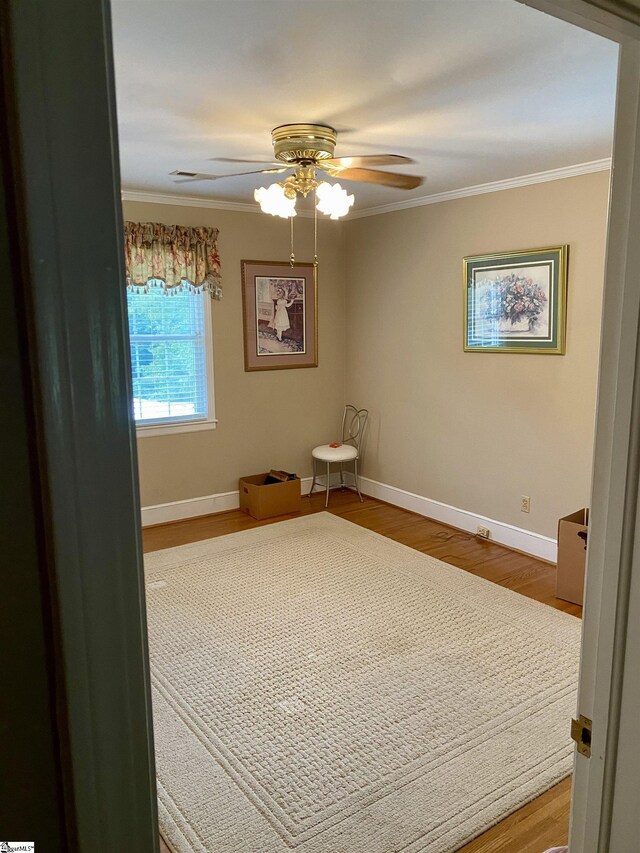 interior space featuring ornamental molding, ceiling fan, and hardwood / wood-style floors