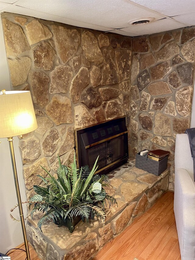 room details with hardwood / wood-style flooring and a fireplace