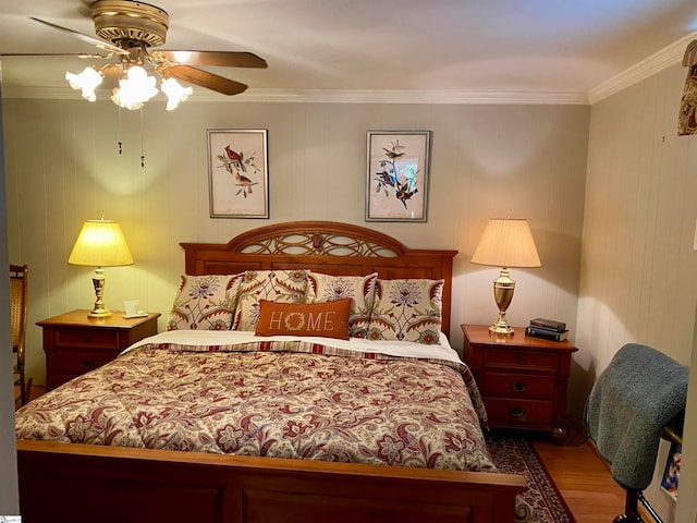 bedroom featuring ornamental molding, wood walls, ceiling fan, and hardwood / wood-style floors