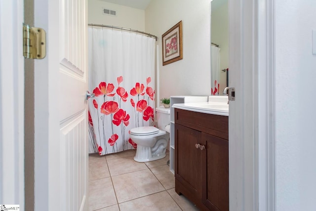 bathroom featuring curtained shower, vanity, toilet, and tile patterned floors