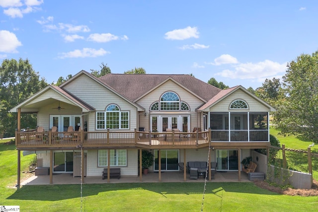 back of house featuring a yard, a wooden deck, and a patio area