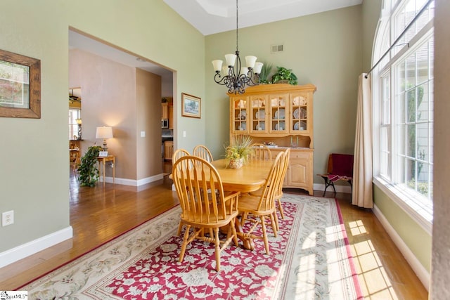 dining space featuring a notable chandelier and light hardwood / wood-style flooring