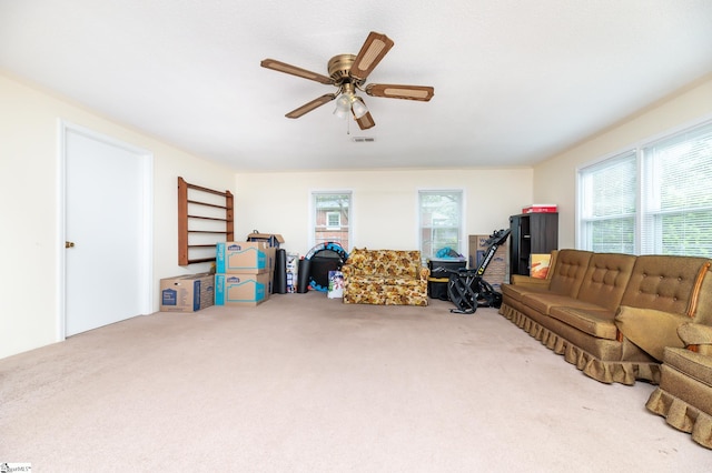 carpeted living room featuring ceiling fan and plenty of natural light