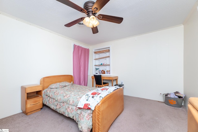 bedroom featuring ceiling fan, a textured ceiling, and carpet flooring