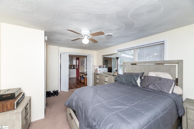 bedroom with ceiling fan and light colored carpet