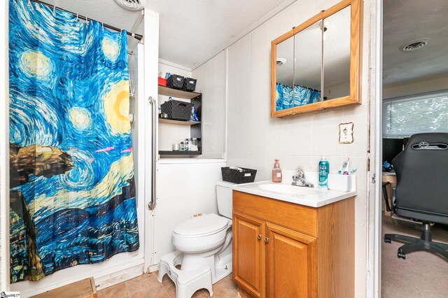 bathroom featuring vanity, toilet, a textured ceiling, tile patterned flooring, and a shower with shower curtain