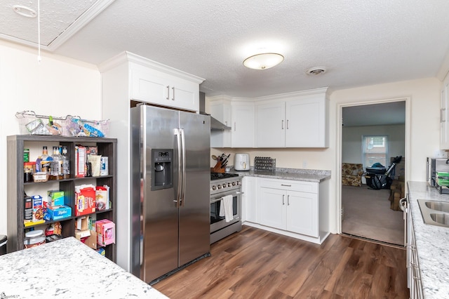 kitchen with a textured ceiling, dark hardwood / wood-style flooring, stainless steel appliances, and white cabinets