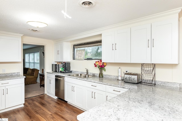 kitchen featuring dishwasher, white cabinetry, plenty of natural light, and sink