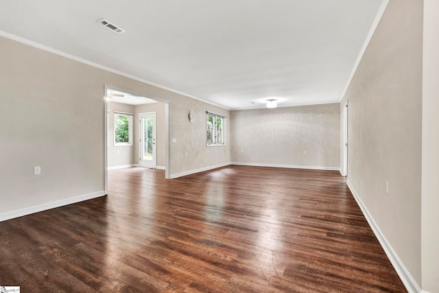 unfurnished living room with ornamental molding and dark hardwood / wood-style floors