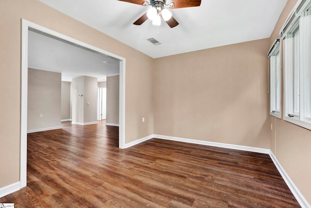 unfurnished room featuring ceiling fan and dark wood-type flooring