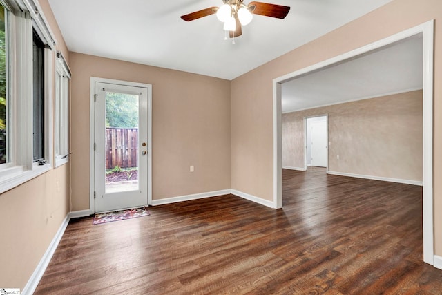 empty room featuring dark hardwood / wood-style flooring and ceiling fan