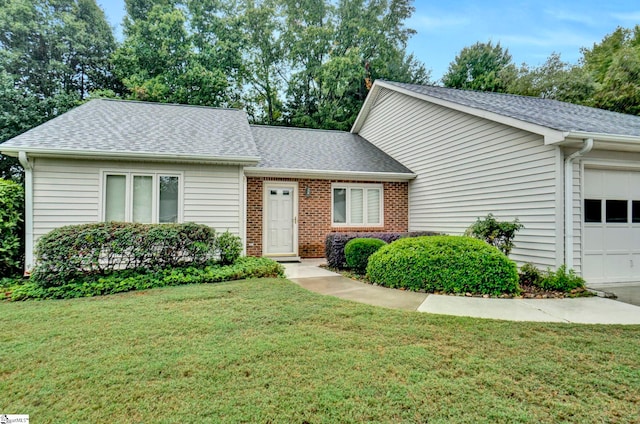 view of front of home with a front lawn and a garage