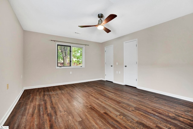 unfurnished room with ceiling fan and dark hardwood / wood-style floors