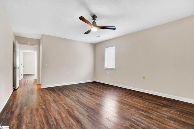 unfurnished room featuring ceiling fan, dark wood-type flooring, and a textured ceiling