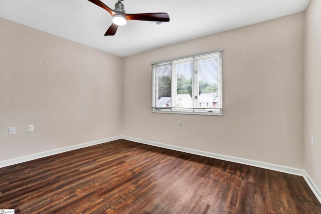 empty room with ceiling fan and dark hardwood / wood-style floors