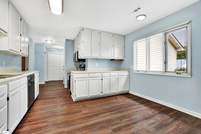 kitchen featuring white cabinetry, appliances with stainless steel finishes, and dark hardwood / wood-style flooring