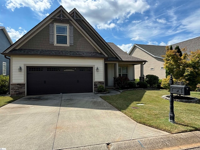 craftsman house with a garage and a front lawn