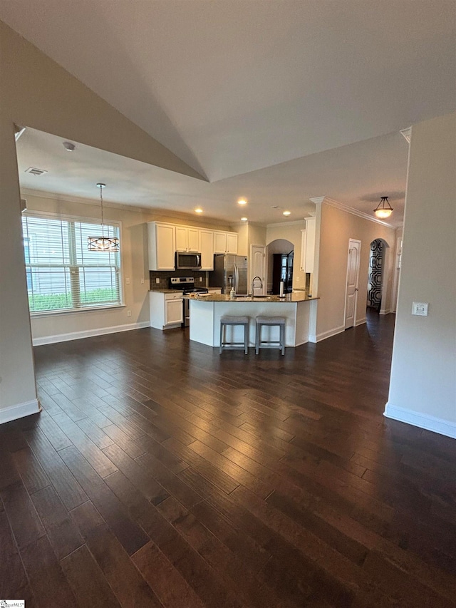 unfurnished living room featuring sink, lofted ceiling, crown molding, and dark wood-type flooring