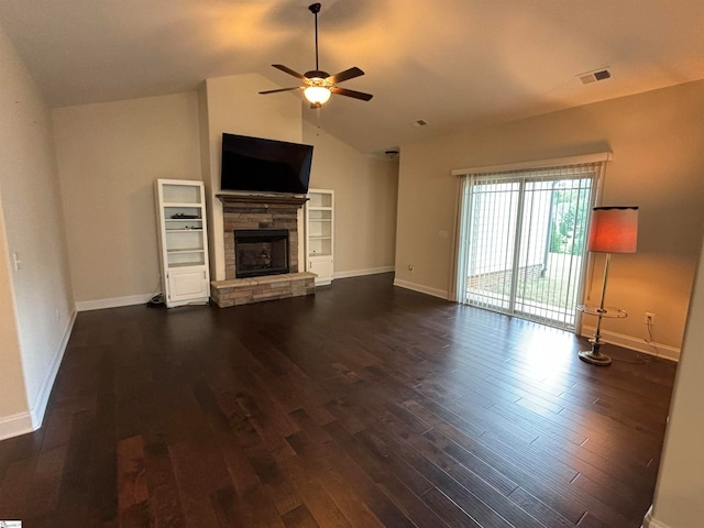 unfurnished living room featuring ceiling fan, a stone fireplace, dark wood-type flooring, and vaulted ceiling