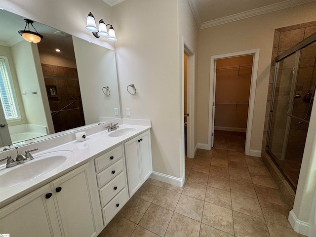 bathroom featuring tile patterned floors, a shower with shower door, vanity, and crown molding