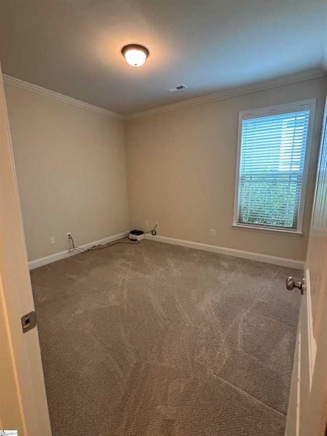 carpeted empty room featuring ornamental molding