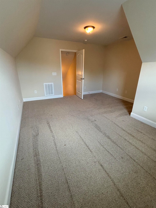 additional living space with carpet and vaulted ceiling