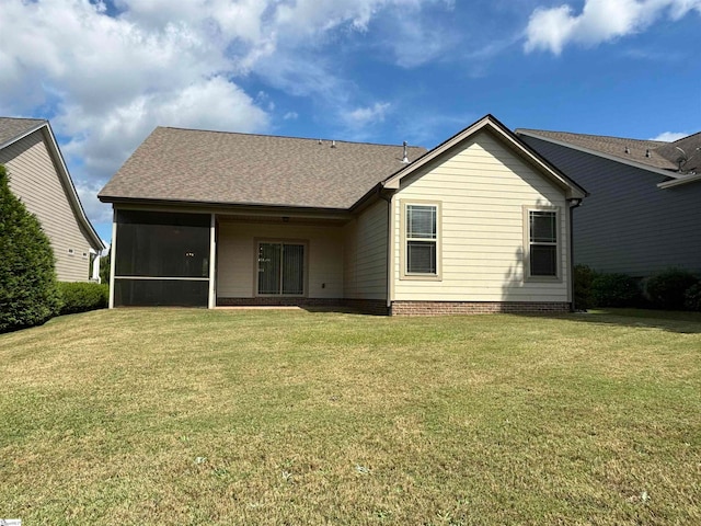 rear view of property with a lawn