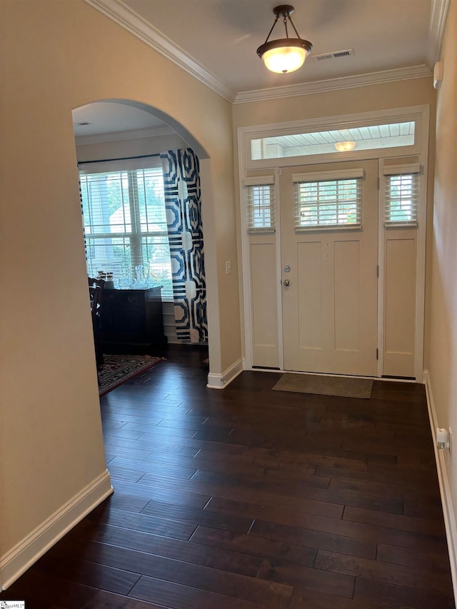 entrance foyer with dark hardwood / wood-style floors, a healthy amount of sunlight, and crown molding