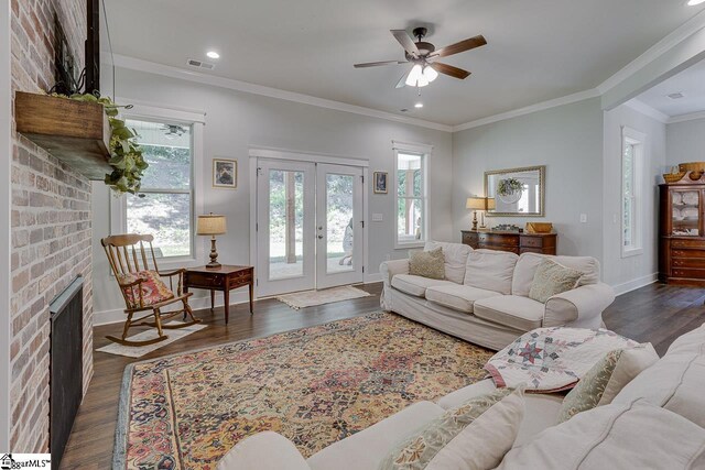 living room featuring a brick fireplace, french doors, dark wood-style floors, visible vents, and a ceiling fan
