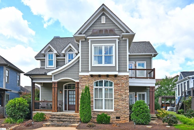 view of front of home with a balcony, covered porch, and central air condition unit