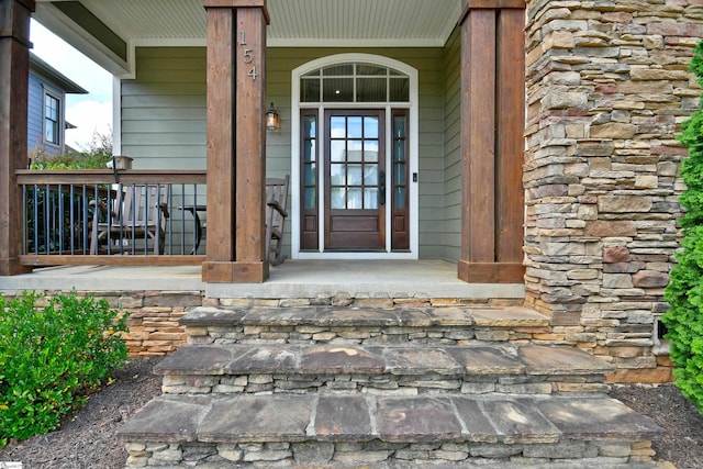 view of exterior entry with a porch