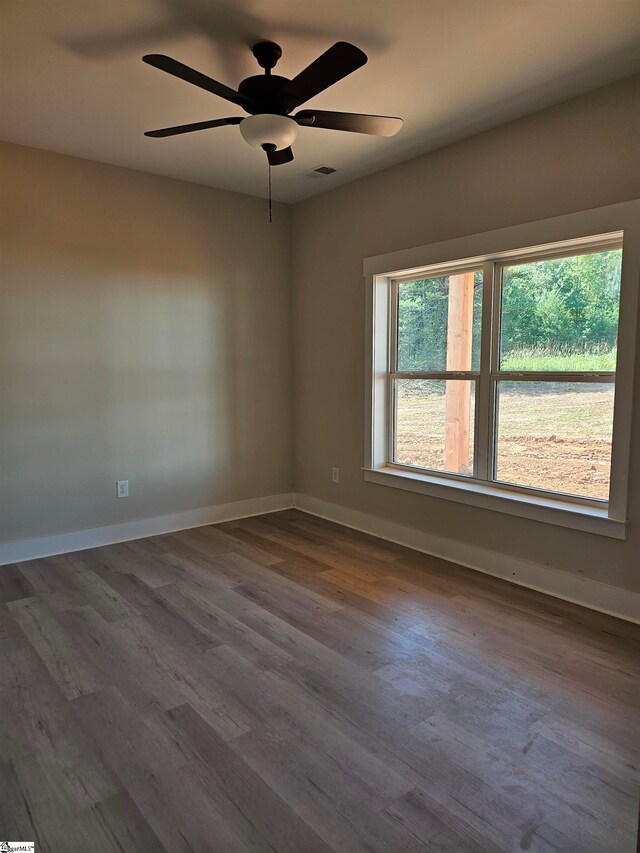 unfurnished room featuring hardwood / wood-style floors and ceiling fan